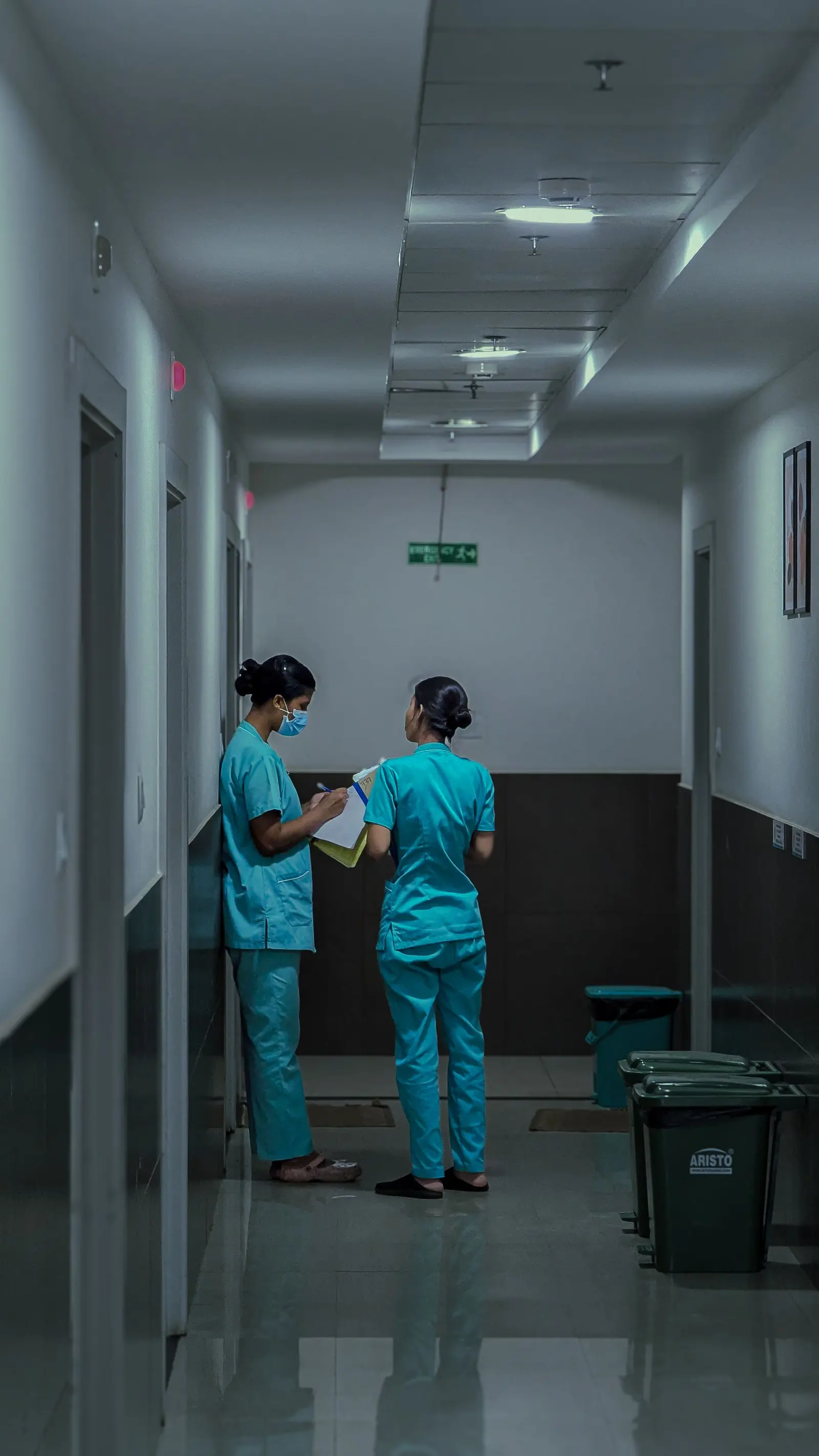 Clinic staff assisting a patient at a reception desk