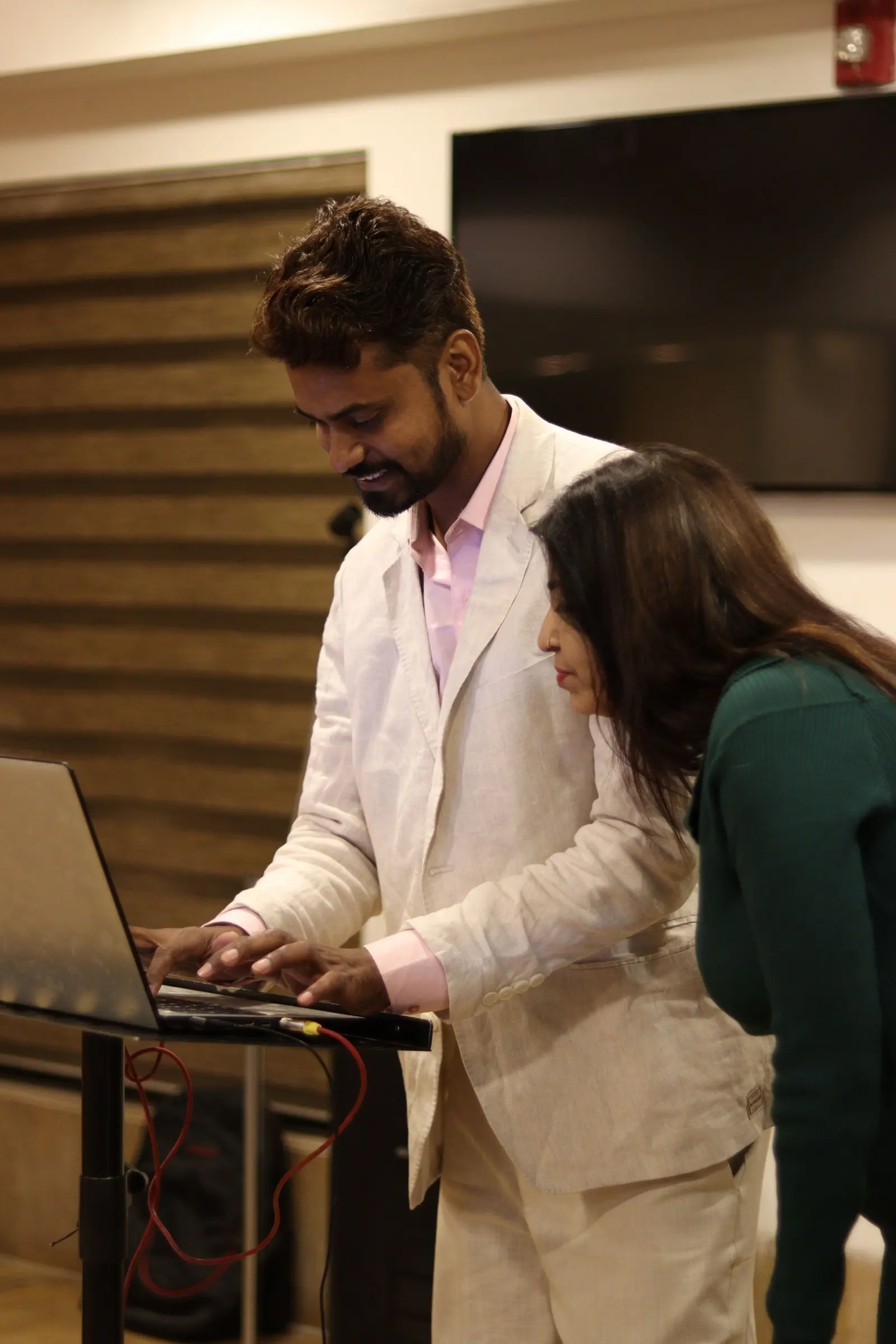 Two colleagues reviewing a project plan on a laptop